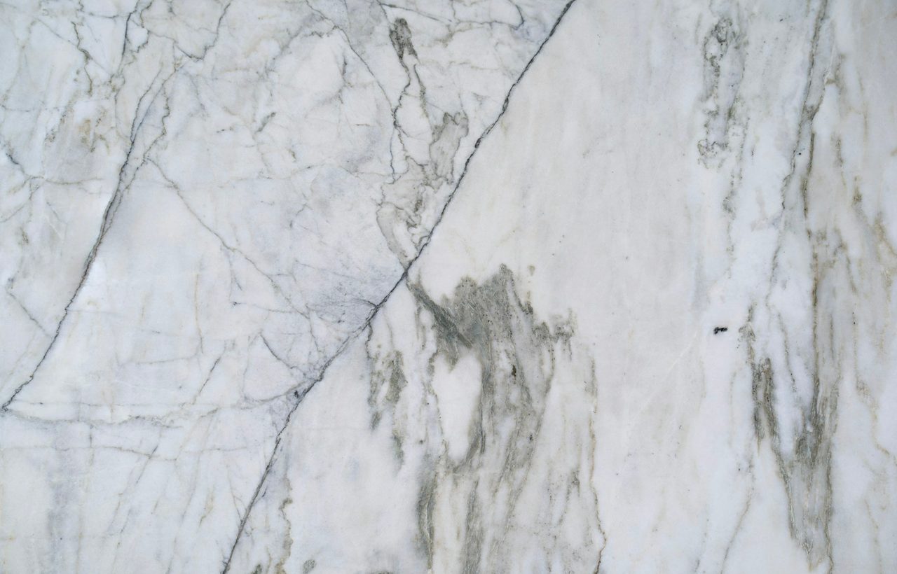 Close view of natural white marble with flowing grey mineral veining