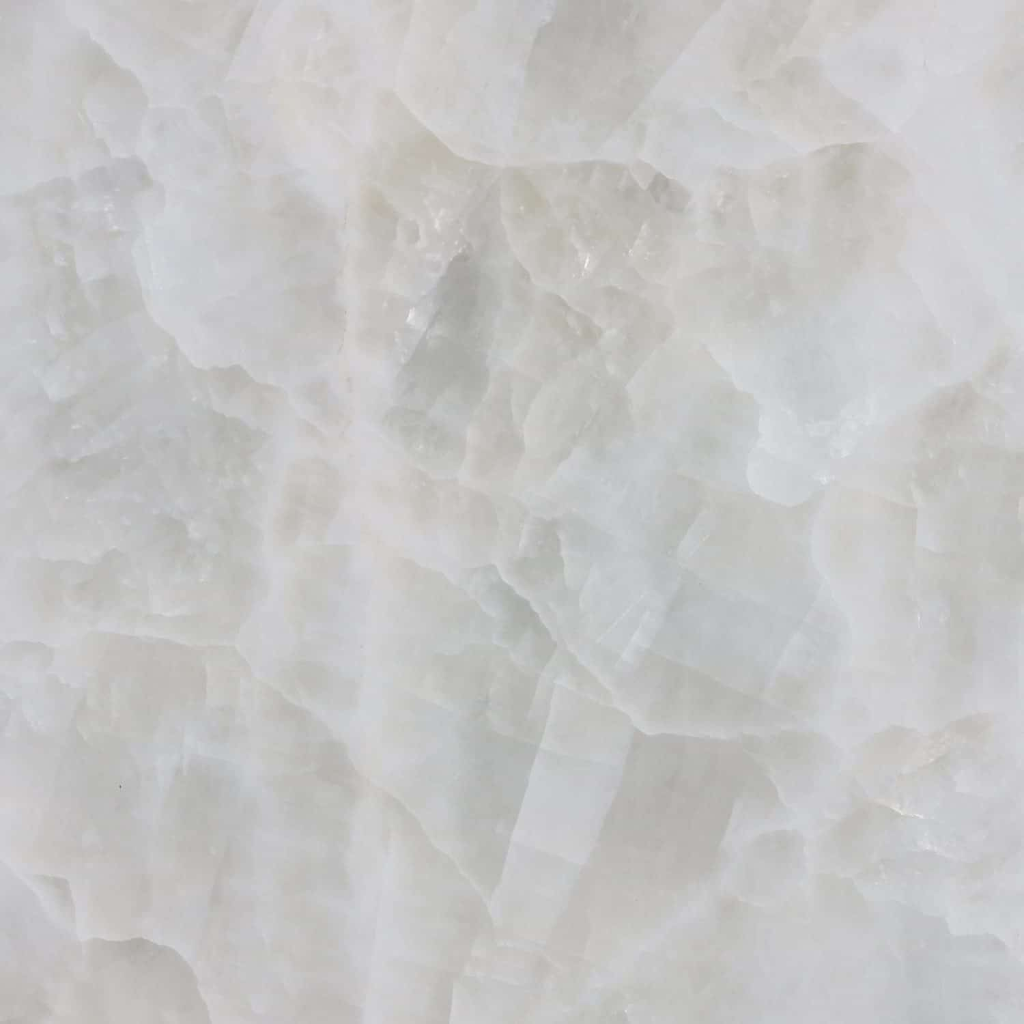 White onyx with softly layered cream and ivory mineral patterns